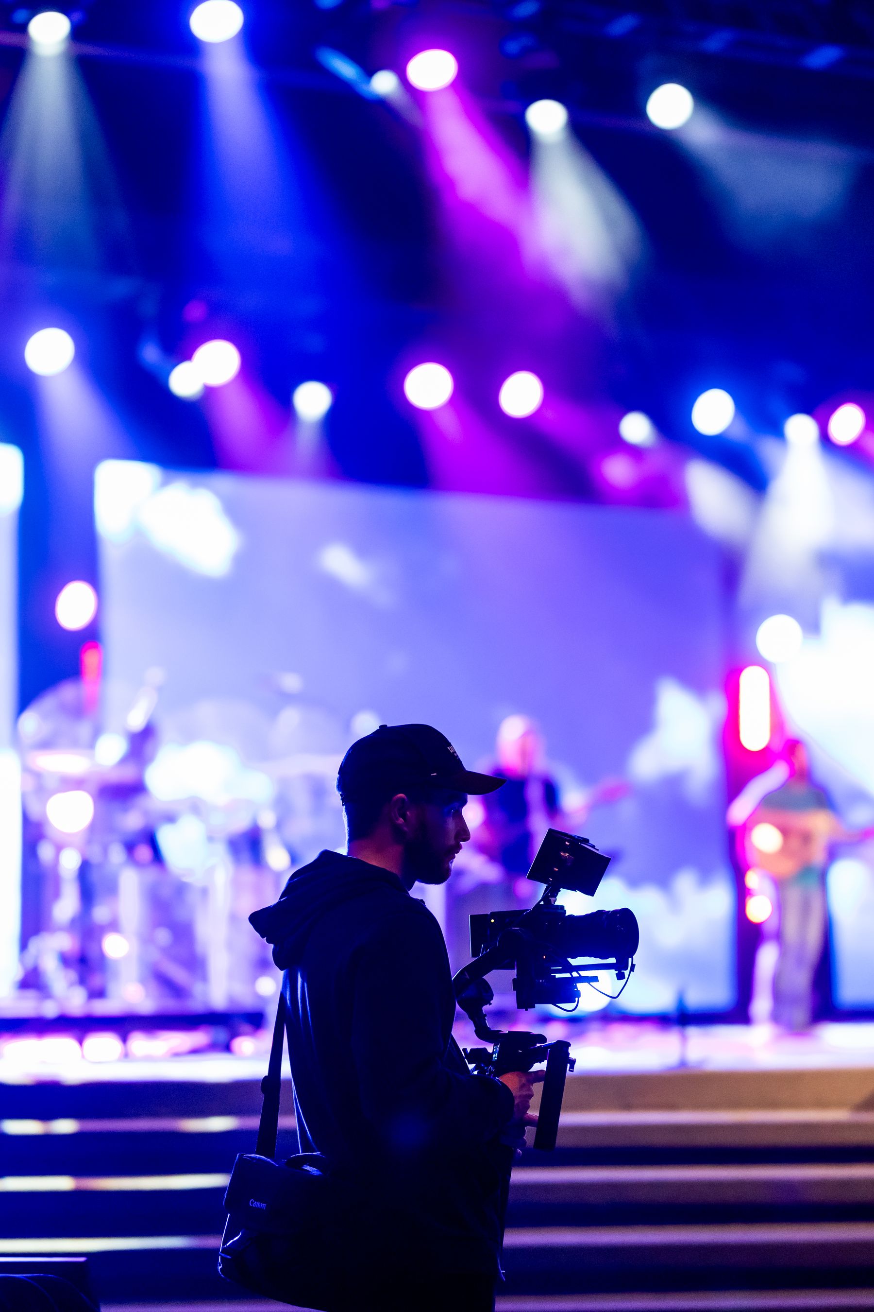 A professional videographer filming a real live performance